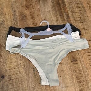 Danskin set of 7 Women's soft thong Panty Black, White, Tan, Cream NWT large